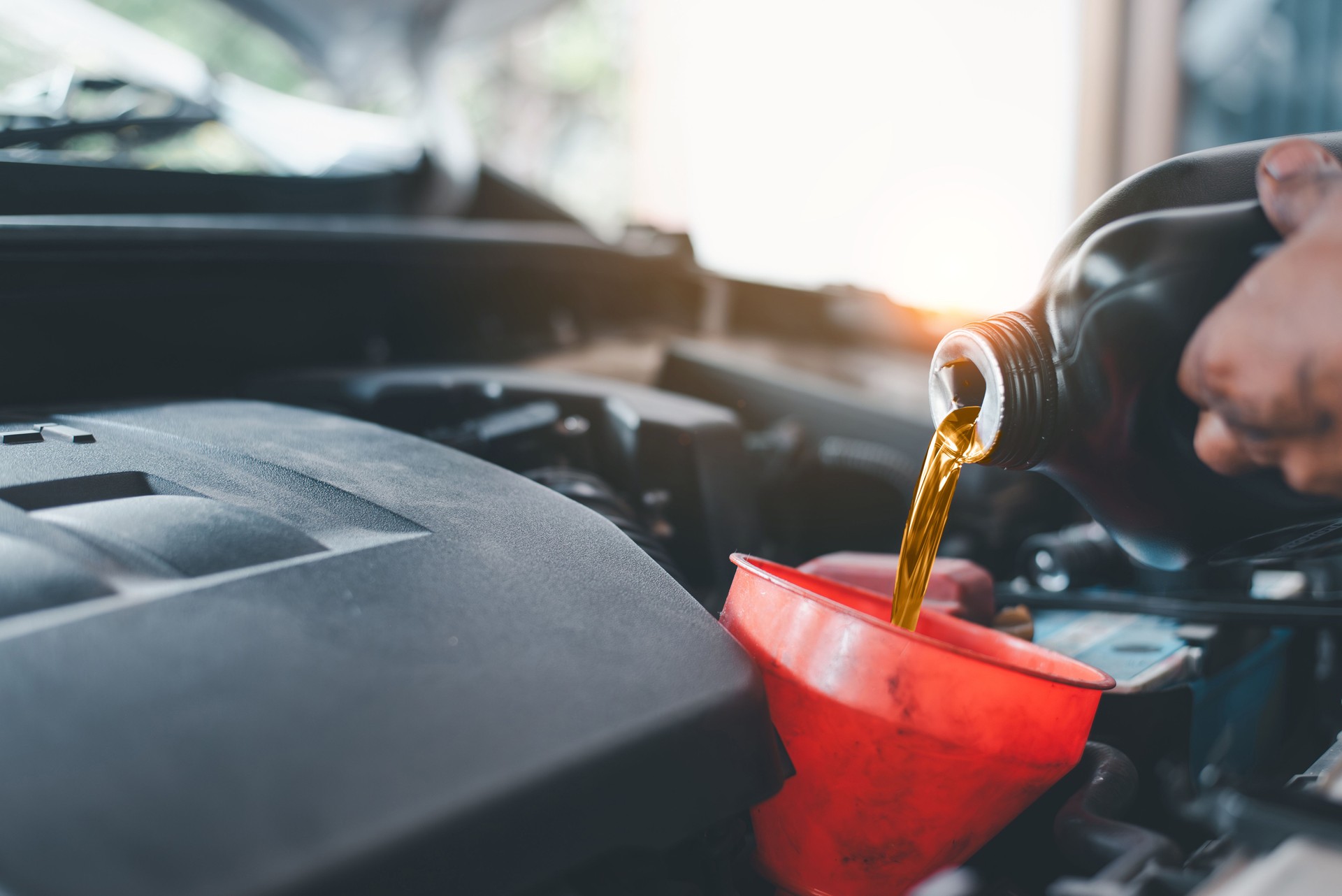 Pouring Engine Oil During Car Maintenance